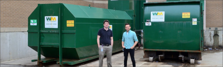 Environmental Waste Specialists standing in front of two waste bins