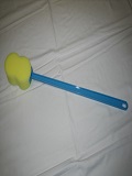 Sponge with handle for use when bathing.  Long handle extends reach without twisting or bending.