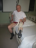 Image of man in bed demonstrating how to get out of bed after hip surgery