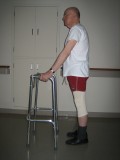 Image of man demonstrating how to use a walker