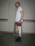 Image of man demonstrating how to use a walker