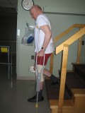 Image of a man demonstrating how to go down the stairs with two crutches