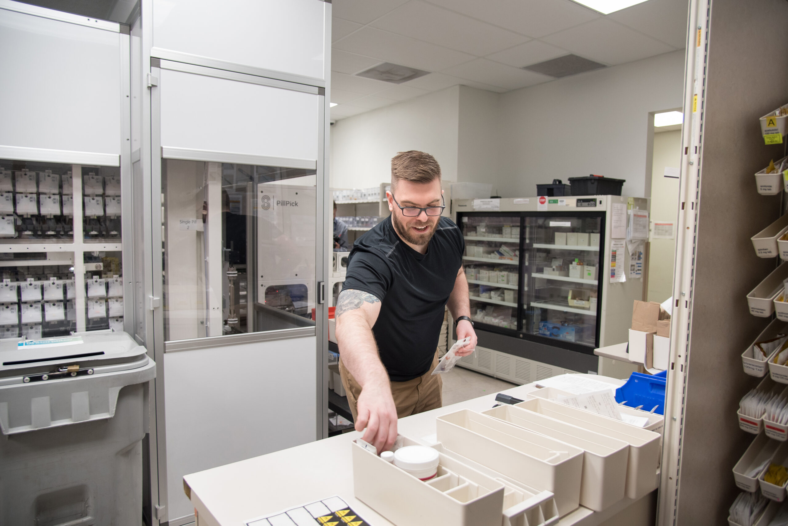 Alex Wyatt, Pharmacy Technician at LHSC prepares to send a medication packet put together by the PillPick machine to an inpatient unit in 2023.