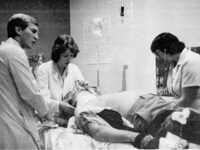 Above: In December of 1986, Dr. Jon Dreyer and his team in the South Street Emergency Department simulated work on an “accident patient” (Harvey Sullivan, president of Victoria Hospital) as part of a demonstration of the ED crew in action for board members touring the department during Emergency Week.