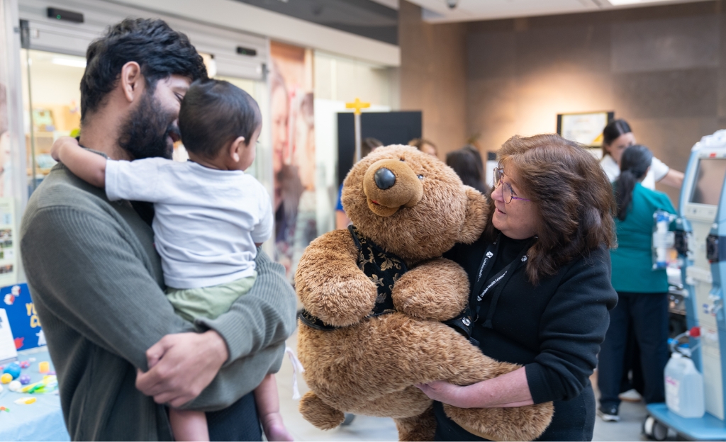 A family visits one of the LHSC 150 department booths at Victoria Hospital 