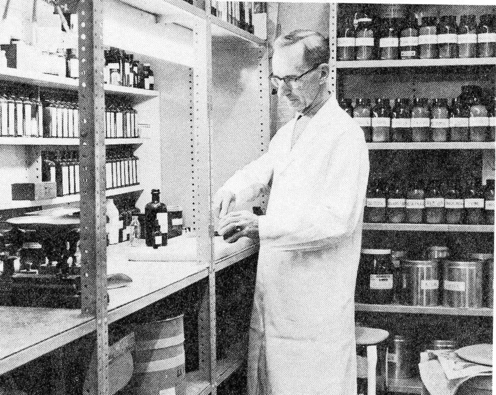 Member of pharmacy team compounding medicine at a worktable in what was known as the Manufacturing Department of the Pharmacy in 1958.