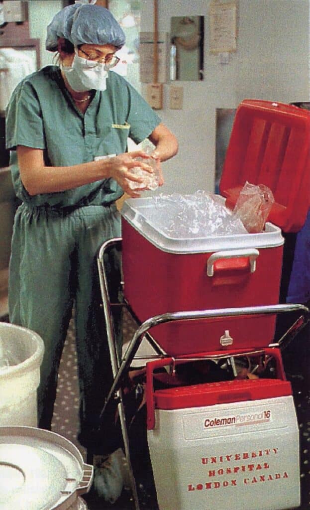 Corinne Weernink, Transplant Coordinator, adds ice to a cooler containing a liver and small bowel in the 1990s. 