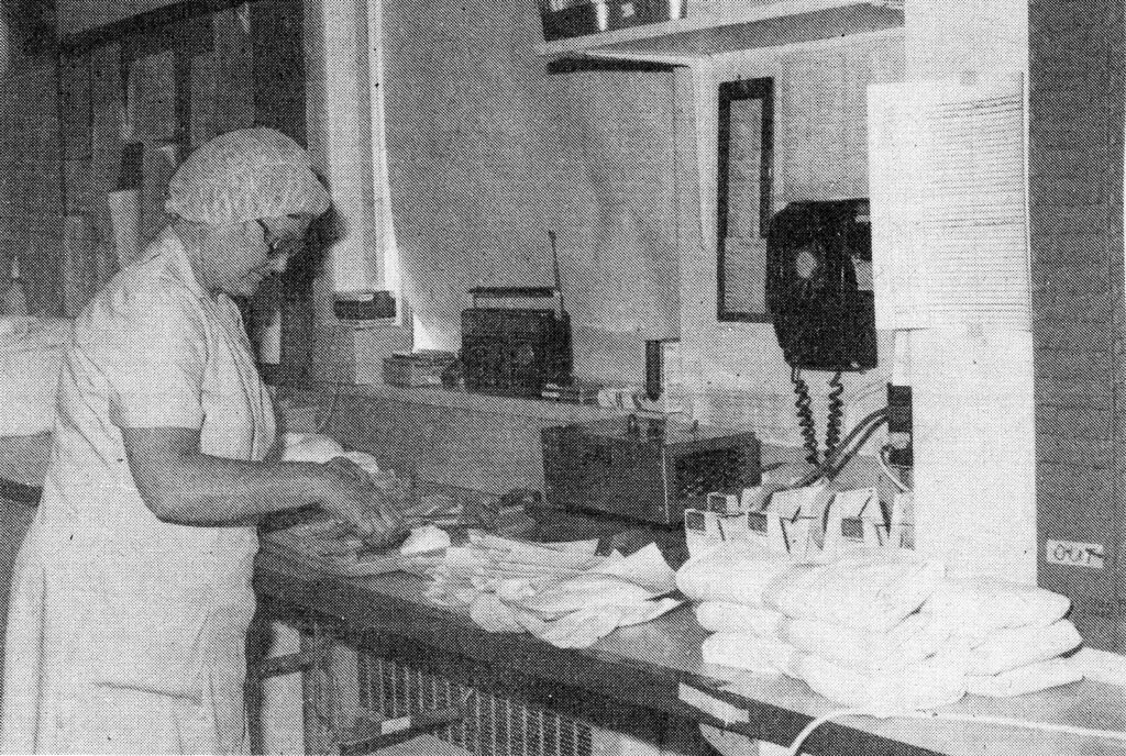 Central Supply Department (CSD) team member, Shirley Morris, packaging double fluffs and gauze from October 1984 Vic-109 newspaper