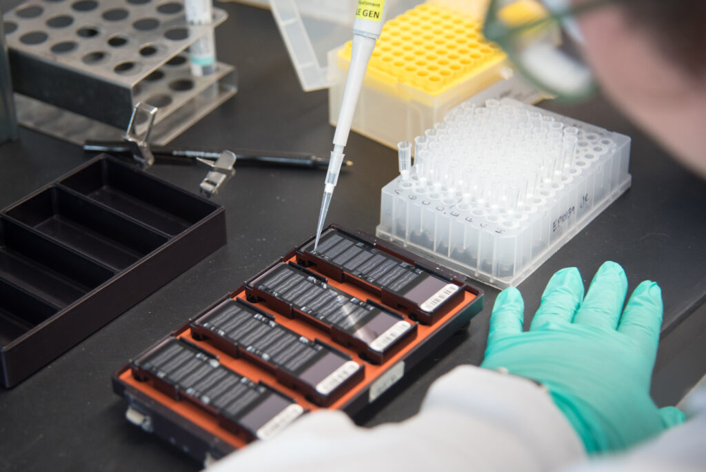 An LHSCRI research staff member tests a sample of blood using EpiSign technology.  