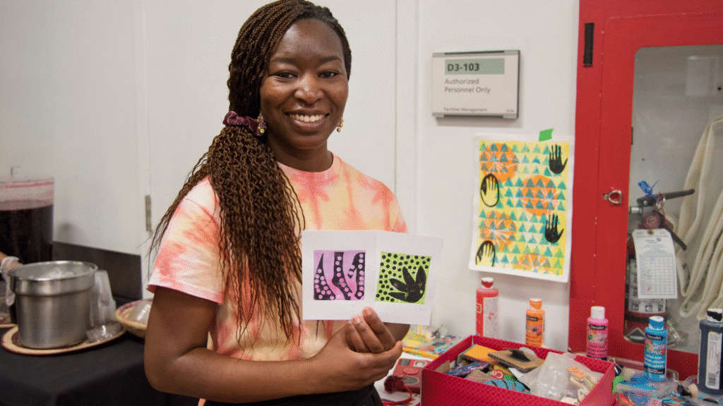 Local artist Amsa Yaro showcases one of the unique pieces of art created using stencils