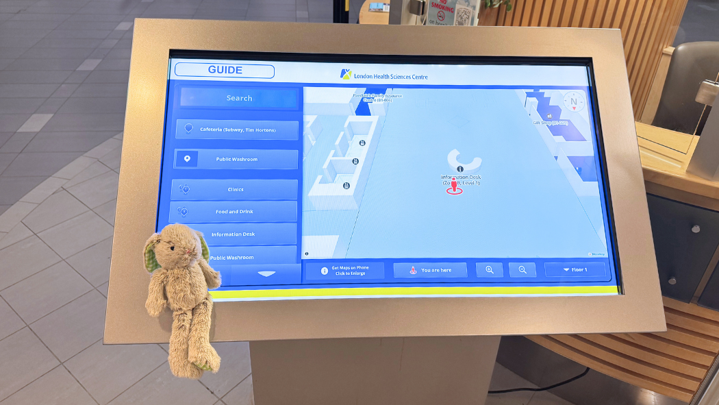 Dr. Hops at a wayfinding kiosk displaying MazeMap.
