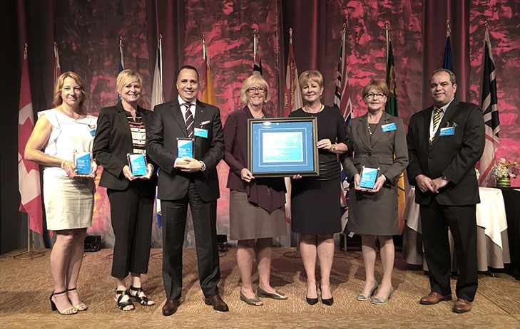 Connecting Care to Home program team pictured holding award for Quality Improvement Initiative. 