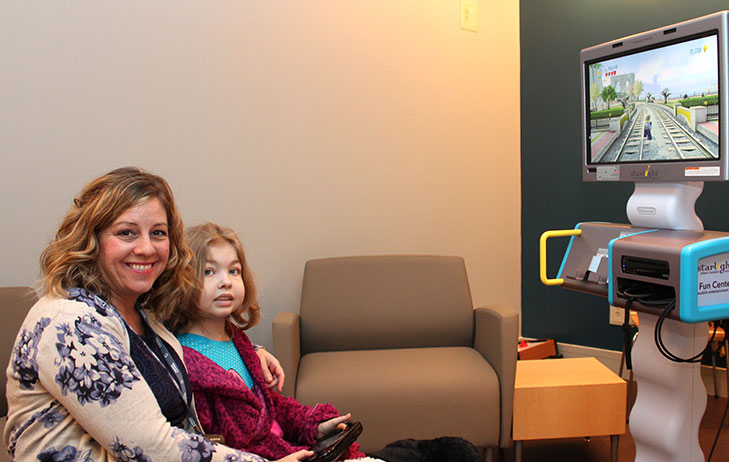 Keanna pictured with her Child Life Specialist Amy playing Wii.