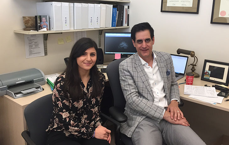 Two medical professional pictured seated in an office.