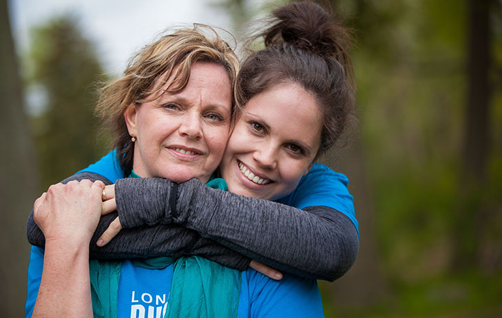 Two female supporters at the London Run for Ovarian Cancer pictured hugging.