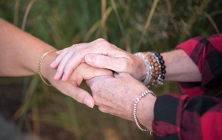 Two hands holding on to each other.