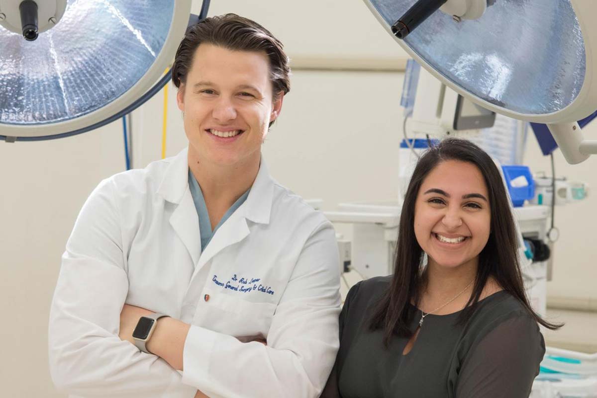 Serena Tejpar and a doctor looking at the camera.