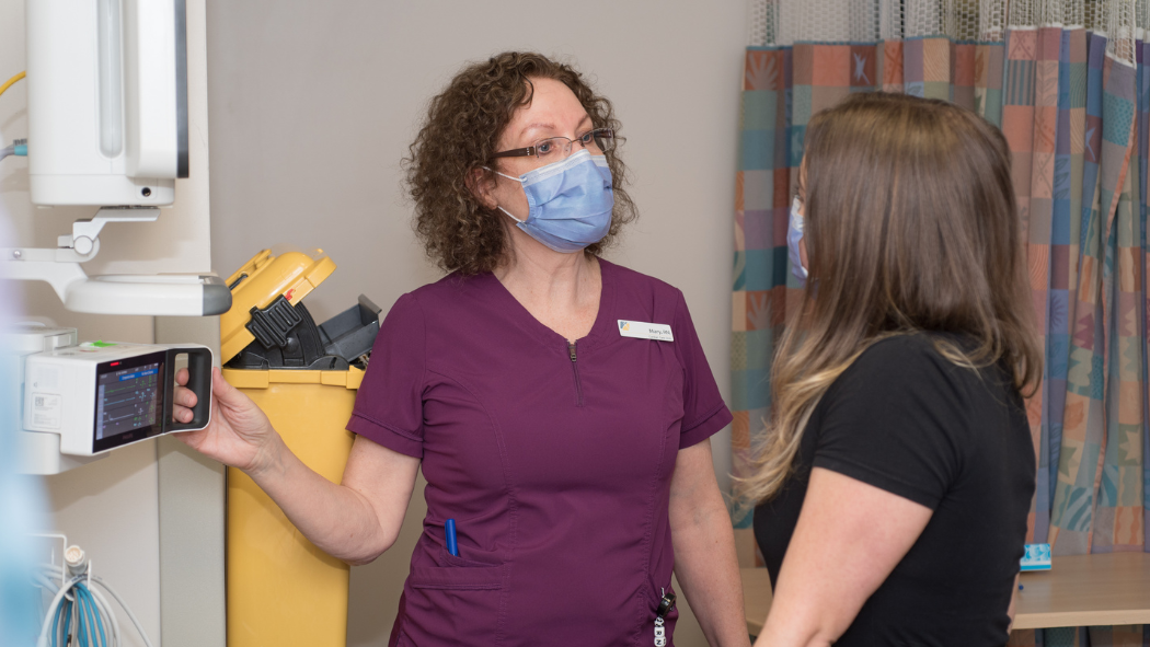 An image of Mary Reed mentoring a nurse