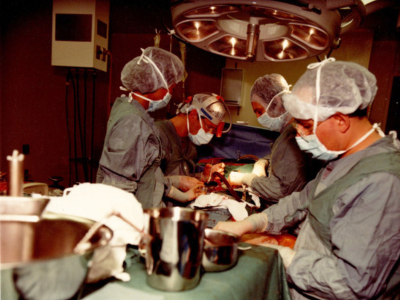 Dr. Neil McKenzie and his team perform surgery in 1980s.