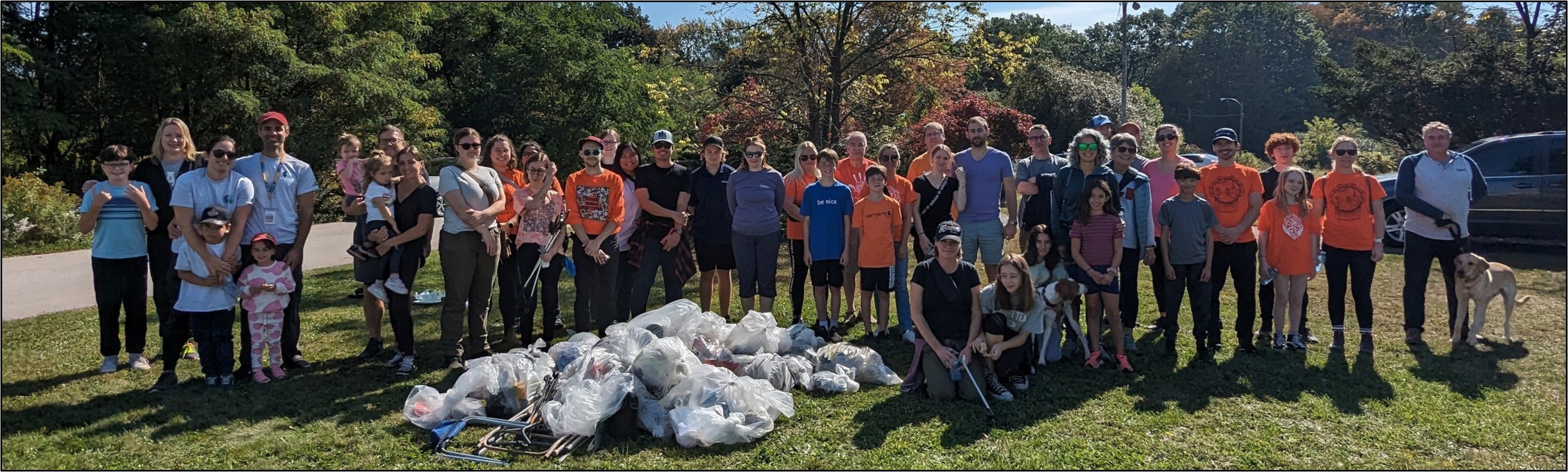 Volunteers from across LHSC, SJHC, and London Environmental Network proudly stand in front of the garbage they cleaned up from Westminster Ponds