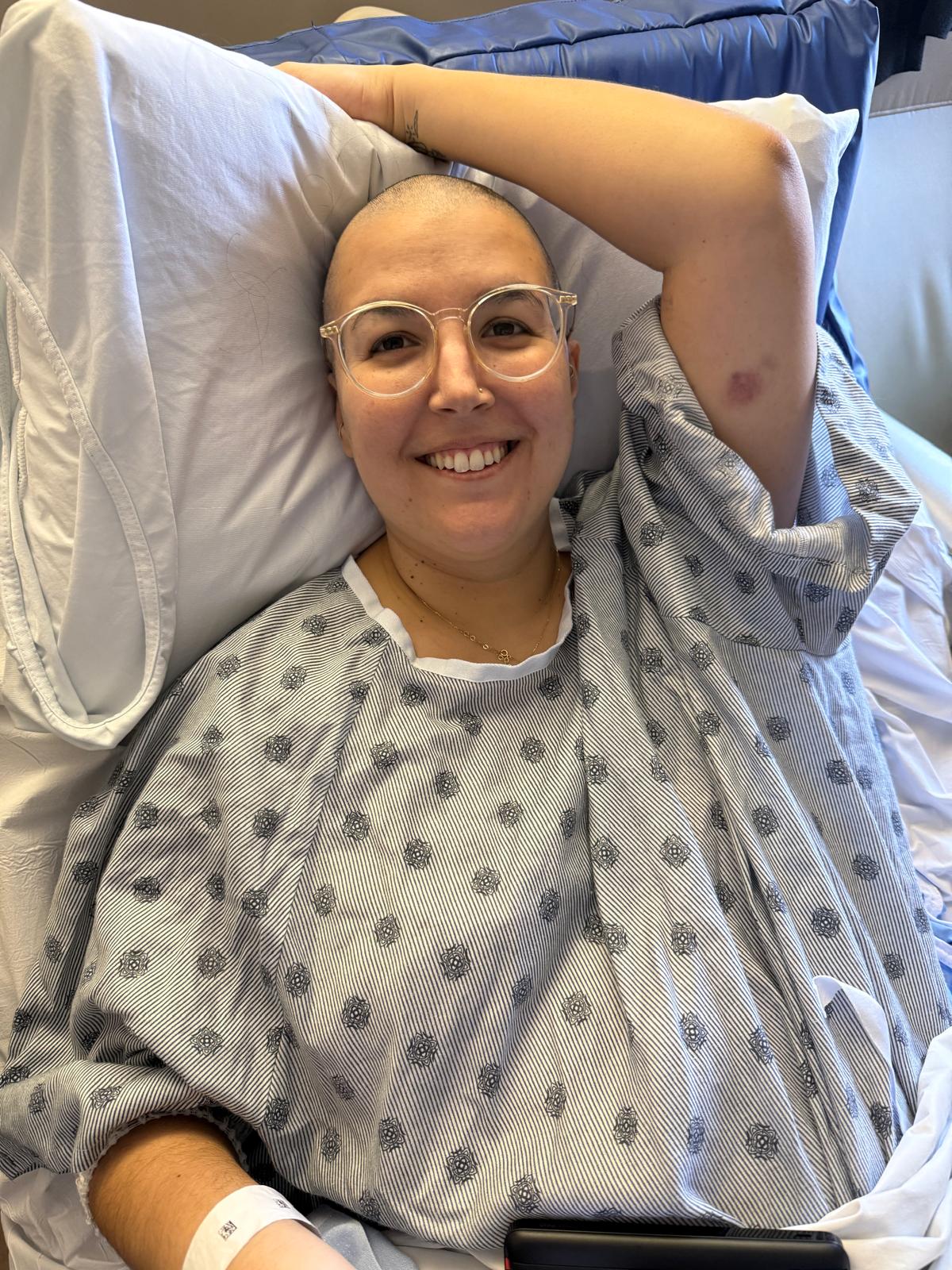 Julide smiling from her hospital bed