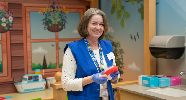 Carroll Spence cleans toys in Ashley's Backyard.