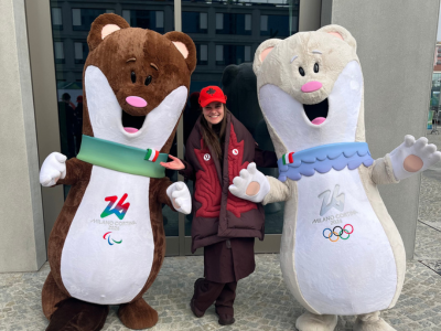 Dr. Kelton with Olympic and Paralympic mascots, Milo and Tina.
