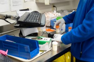 Above: A Nutrition Technician carefully weighs and labels breast milk to go into storage.  