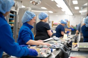 Dietary workers prepare the 945 trays that go out with each meal service