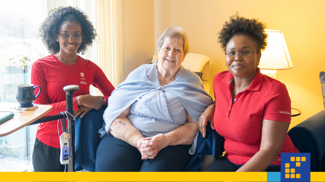 Two care providers sitting with a patient
