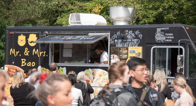 Event attendees gather by the UH 50 celebration food trucks.