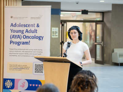 Ishtar speaking at podium in hospital atrium