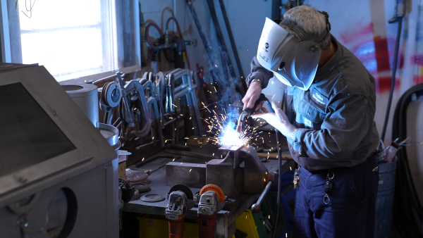 Walter welding in the machine shop.