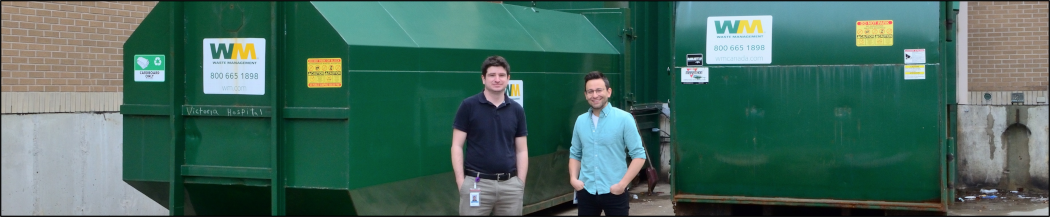 LHSC Waste Specialists standing in front of two large waste compactors