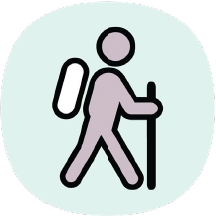 Icon of a person walking with a backpack and a stick