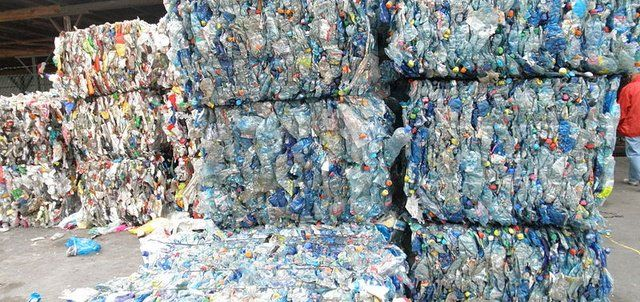 Photograph of baled materials which are large compressed cubes of similar recycled products such as plastic bottles.