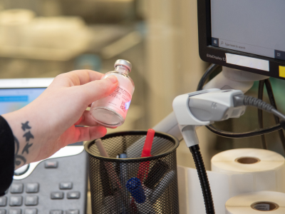 hand holding bottle in front of scanner