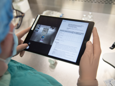 technician using iPad to take photos of product