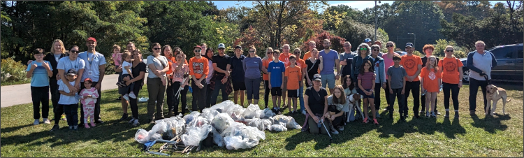 Volunteers from LHSC, SJHC, and London Enviornmental network standing in front of all the garbage collected during the Westminster Ponds Fall Cleanup.