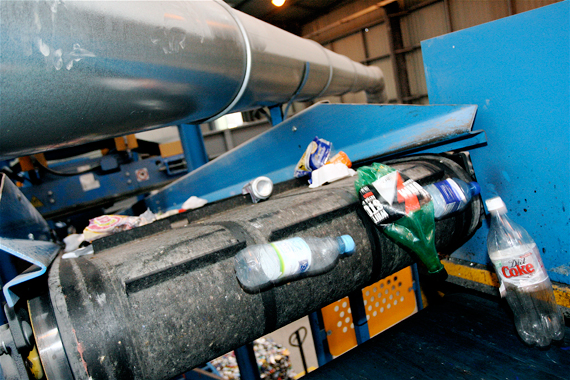 Photograph of empty plastic bottles coming off a conveyor belt