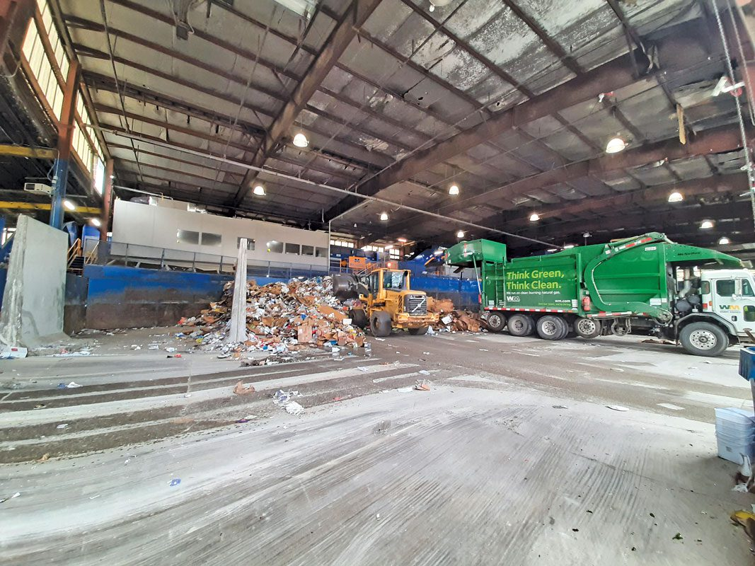 Recycling collection trucks dumping their collected material directly on a tip floor at the MRF