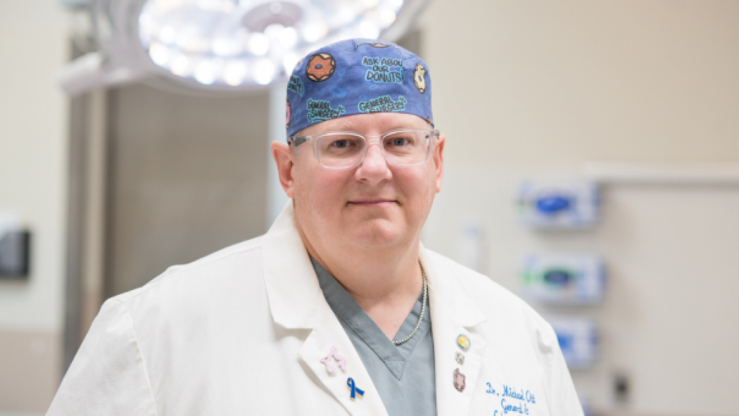 Dr. Michael Ott, Department Head, Oncology at London Health Sciences Centre standing in a doctor's coat in an operating room.