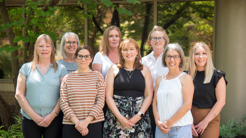 Picture of the Oncology Patient Navigation Program (OPNP) standing outside in front of greenery.