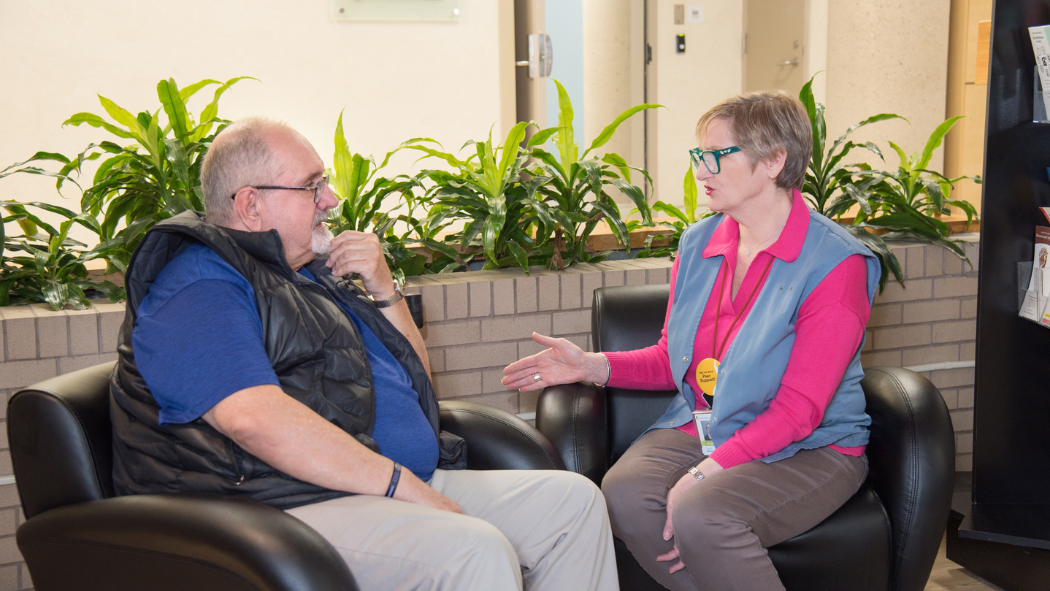 Jeff Nielsen, family member participant in the Peer Support Program and London Health Sciences Centre volunteer, Carol Wilkinson, converse as they site next to each other in the hospital. 