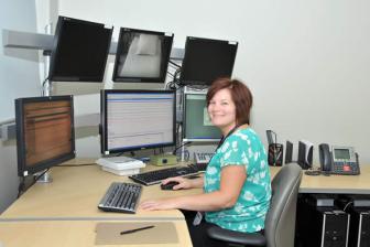 Sleep laboratory team member working at a computer.