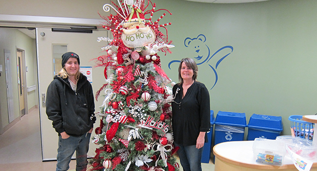 Donna Yundt and her son Baydon pose by one of this year’s three decorated Christmas trees on the paediatric inpatient unit at LHSC’s Children’s Hospital.