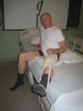 Image of man demonstrating how to get into of bed after hip surgery
