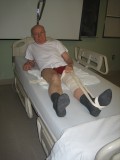 Image of man demonstrating how to get into of bed after hip surgery