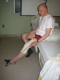 Image of man removing sock with a reacher