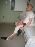 Image of man putting on sock with a sock aid
